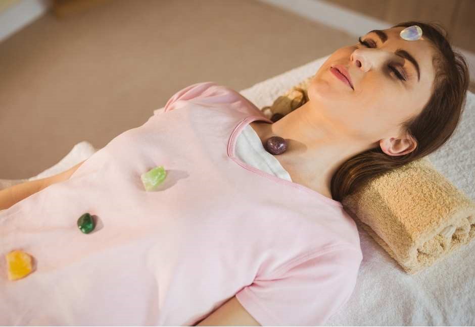 crystal healing image of person laying down with crystals on the body