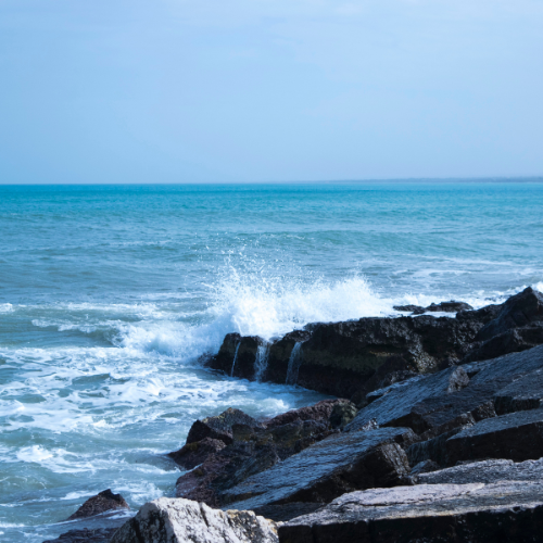 beach water hitting rocks